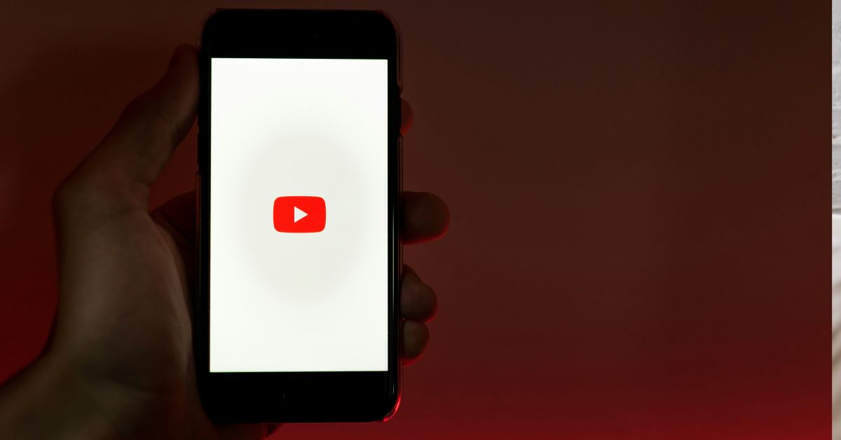 Person-holding-phone-with-Youtube-open.jpg
